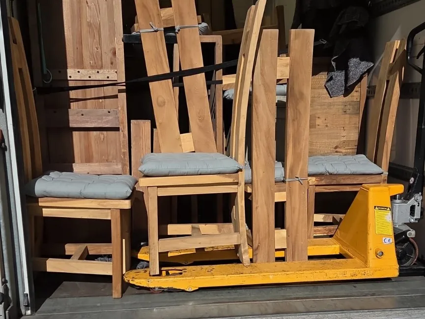 Wooden household furniture carefully loaded into a Luton van for a home removal